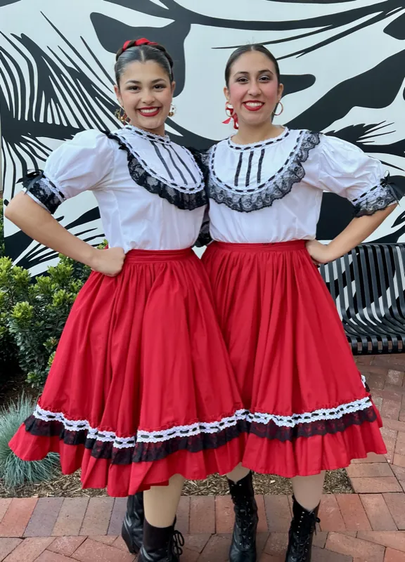 Ballet Folklórico Mi Herencia teen dancers performing in red folklorico skirts