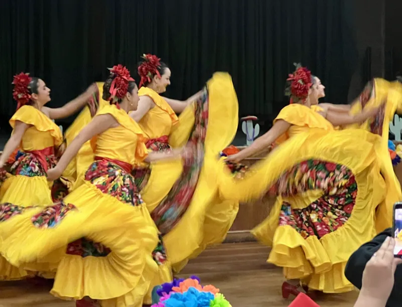Ballet Folklórico Mi Herencia dancers gathered in traditional folklorico attire