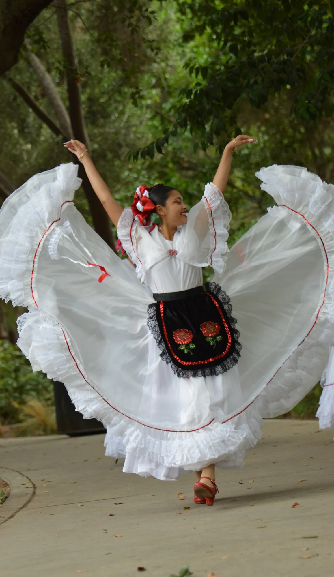 Ballet Folklórico Mi Herencia dancer in white Veracruz dress